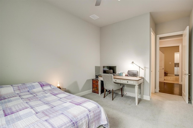 bedroom featuring light carpet, visible vents, a ceiling fan, and baseboards