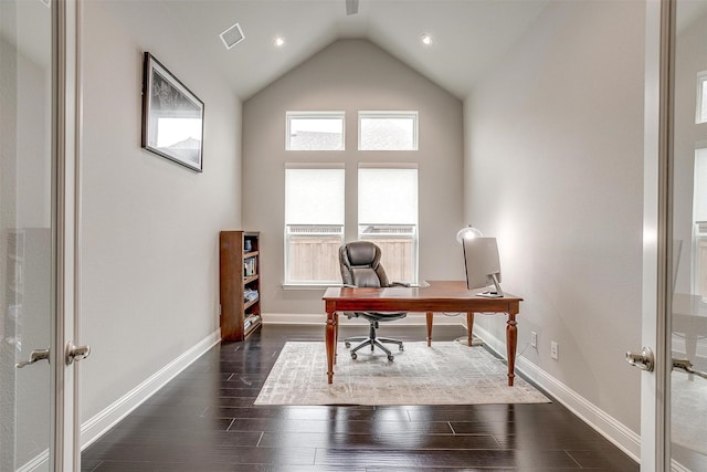 home office featuring lofted ceiling, visible vents, dark wood finished floors, and baseboards