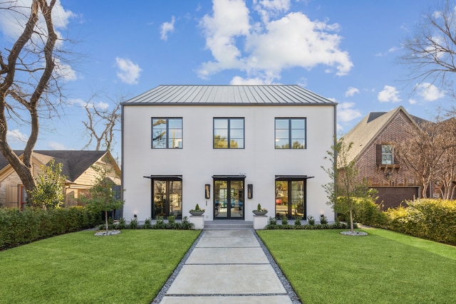 view of front of property with a front yard, french doors, metal roof, and a standing seam roof