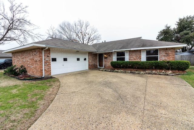 ranch-style home featuring concrete driveway, brick siding, a front lawn, and an attached garage