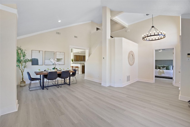 dining area with light wood-type flooring, visible vents, and a notable chandelier