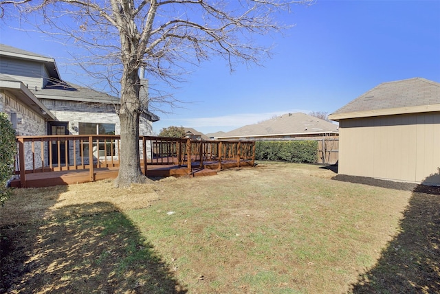 view of yard with fence and a wooden deck