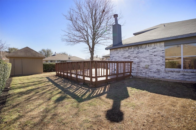 view of yard with an outdoor structure, a deck, and a storage shed