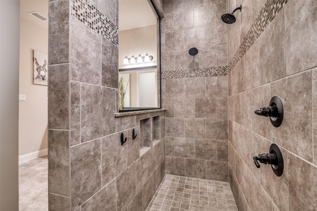 full bathroom featuring visible vents and tiled shower