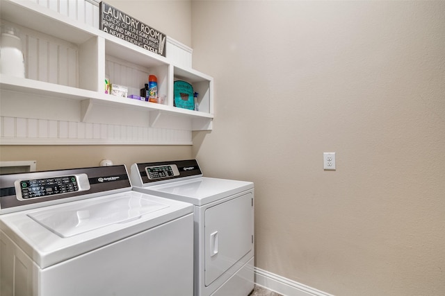 washroom featuring washer and dryer, laundry area, and baseboards