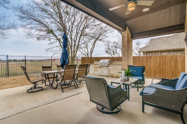 view of patio / terrace featuring outdoor dining area, area for grilling, a fenced backyard, and a ceiling fan