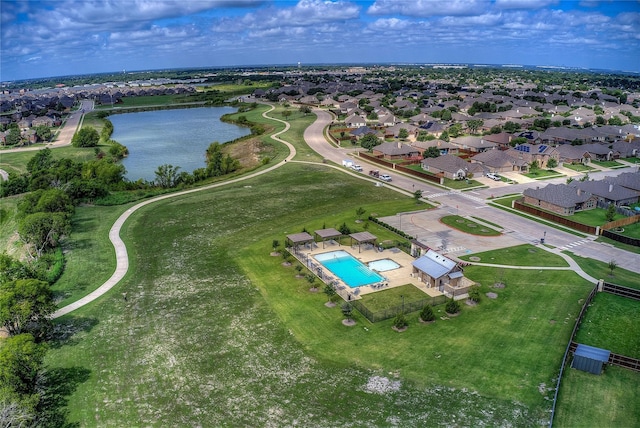 drone / aerial view with a water view and a residential view