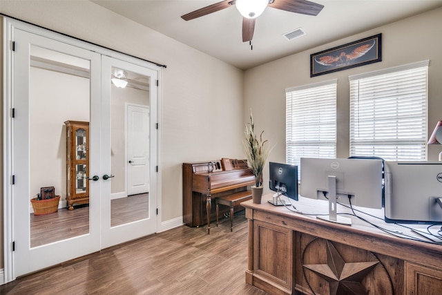 office space featuring wood finished floors, visible vents, french doors, and ceiling fan