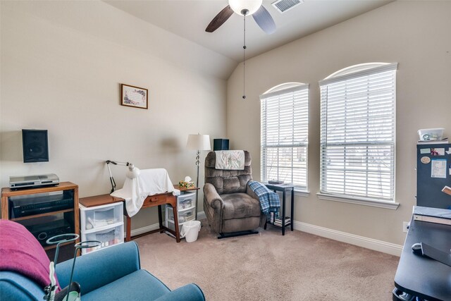 living area featuring a ceiling fan, a healthy amount of sunlight, visible vents, and carpet floors