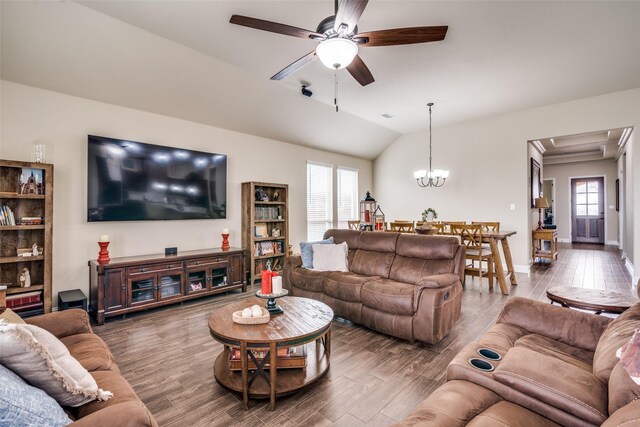 living area with a wealth of natural light, vaulted ceiling, ceiling fan with notable chandelier, and wood finished floors