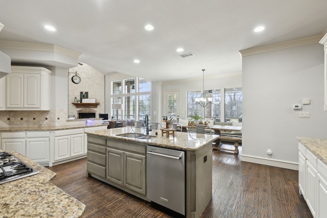 kitchen featuring visible vents, ornamental molding, white cabinetry, stainless steel appliances, and a fireplace