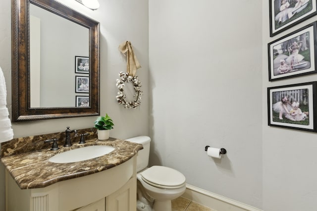 bathroom featuring tile patterned floors, baseboards, toilet, and vanity