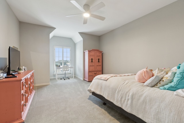 bedroom featuring baseboards, light carpet, lofted ceiling, and a ceiling fan