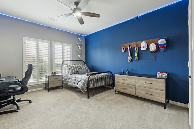 bedroom featuring visible vents, a ceiling fan, baseboards, and carpet floors