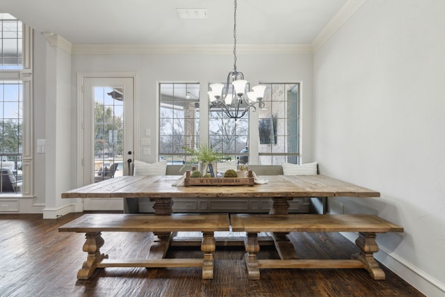 dining area with dark wood finished floors, breakfast area, crown molding, and a wealth of natural light