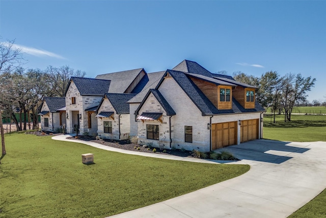 view of front of property with a garage, stone siding, driveway, and a front lawn