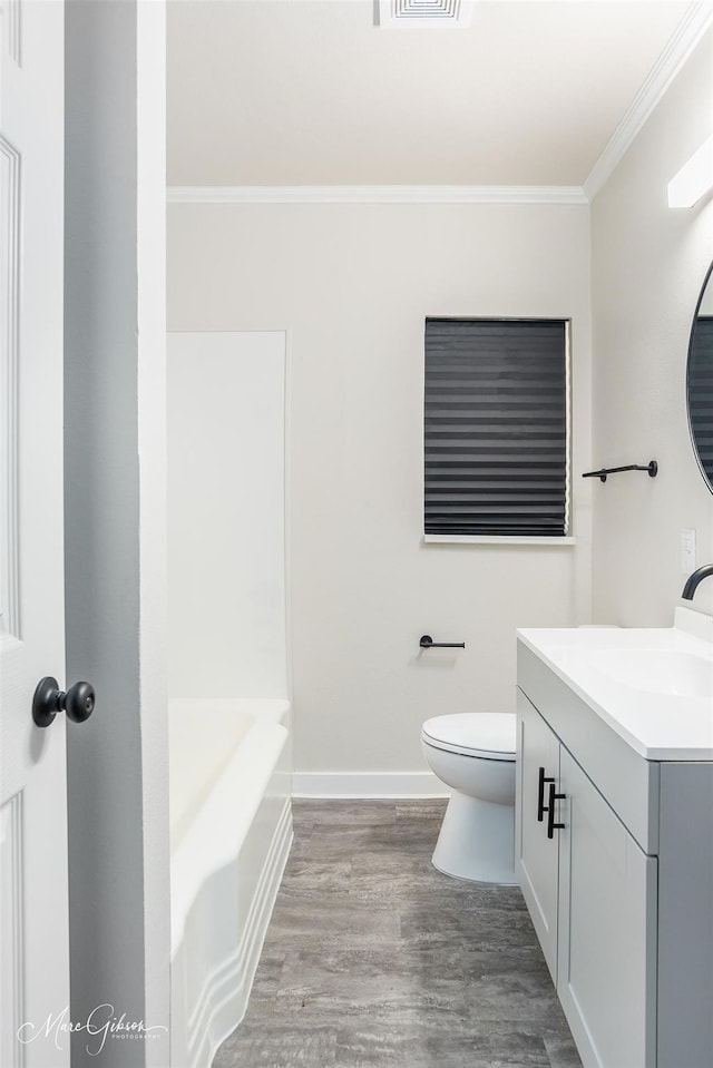 full bath featuring baseboards, toilet, ornamental molding, wood finished floors, and vanity