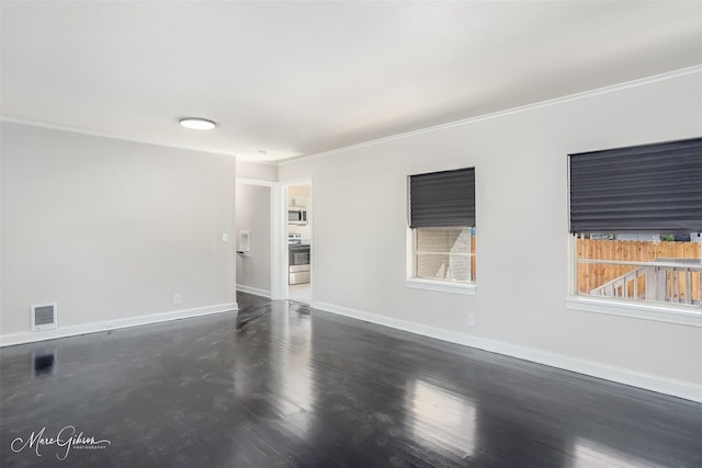 unfurnished room featuring ornamental molding, visible vents, dark wood finished floors, and baseboards