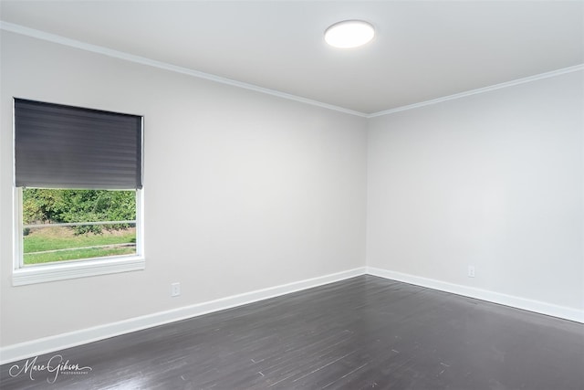 unfurnished room featuring ornamental molding, dark wood-style flooring, and baseboards