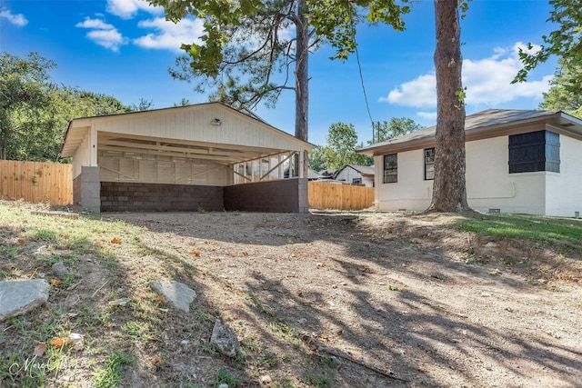 view of property exterior featuring crawl space, fence, and brick siding