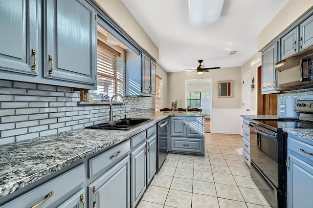 kitchen featuring light tile patterned floors, ceiling fan, a sink, visible vents, and black appliances