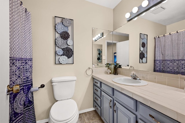 full bathroom with baseboards, visible vents, toilet, tile patterned floors, and vanity