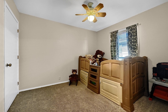 bedroom with dark colored carpet, a ceiling fan, and baseboards