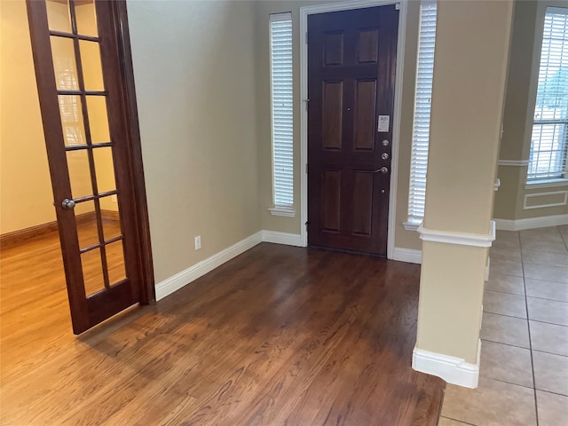 entryway with baseboards and wood finished floors