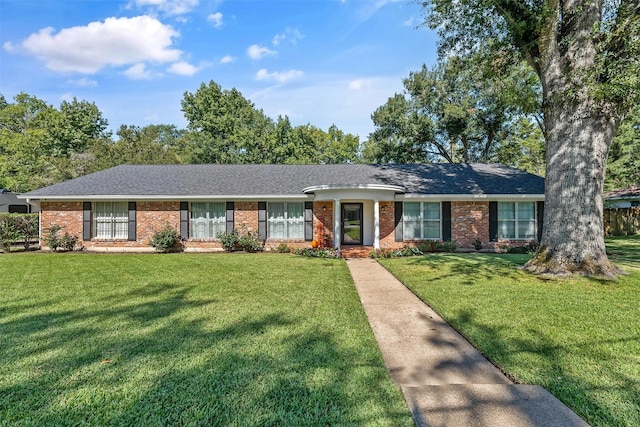 single story home with a shingled roof, brick siding, and a front lawn