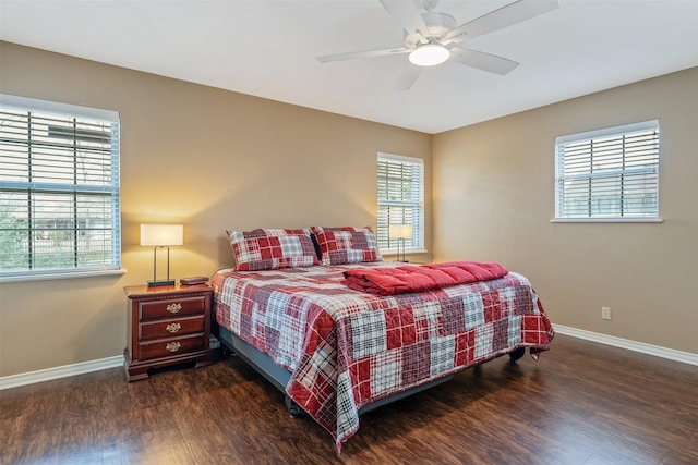 bedroom featuring dark wood finished floors, baseboards, and ceiling fan