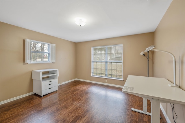 interior space featuring baseboards, dark wood-style flooring, and a wealth of natural light