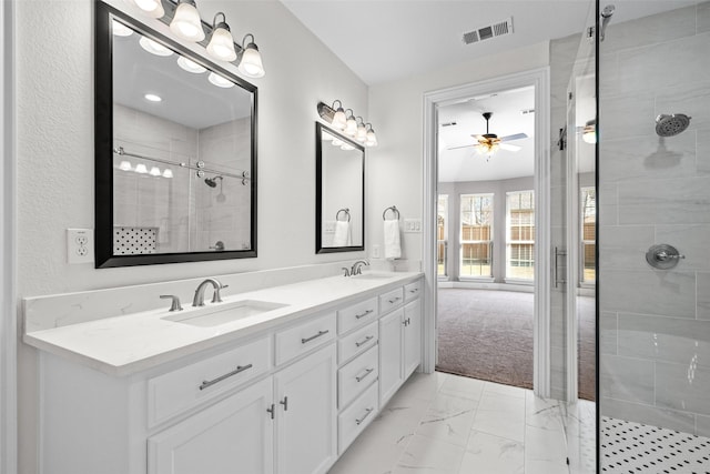 bathroom featuring marble finish floor, visible vents, a sink, and double vanity