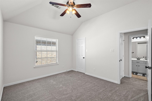 unfurnished bedroom with lofted ceiling, ceiling fan, light colored carpet, visible vents, and baseboards