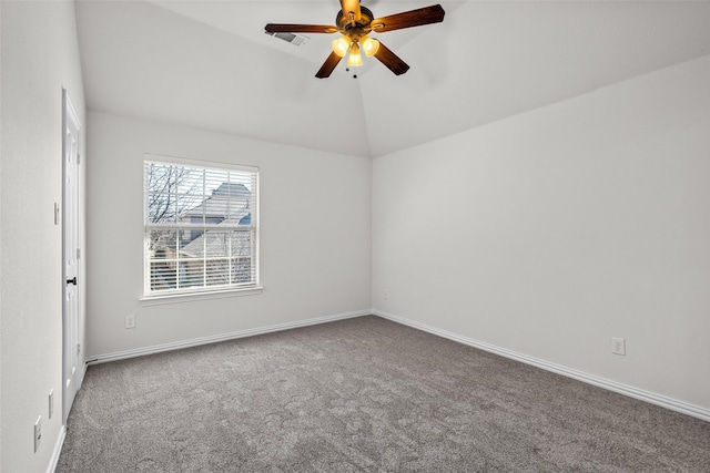 carpeted spare room featuring vaulted ceiling, baseboards, and ceiling fan