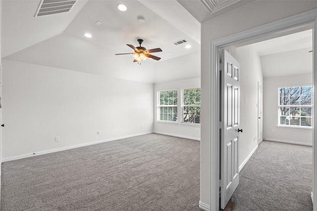 unfurnished room with lofted ceiling, carpet floors, visible vents, and baseboards