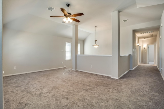 unfurnished room with carpet floors, lofted ceiling, visible vents, and baseboards