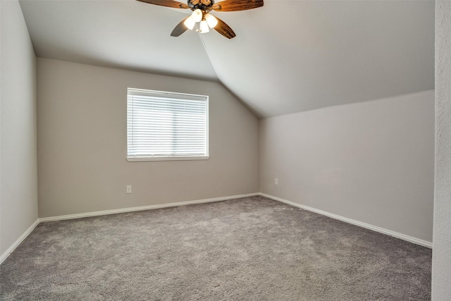 bonus room with lofted ceiling, carpet flooring, a ceiling fan, and baseboards