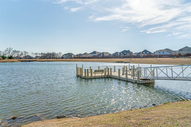 view of dock featuring a residential view and a water view