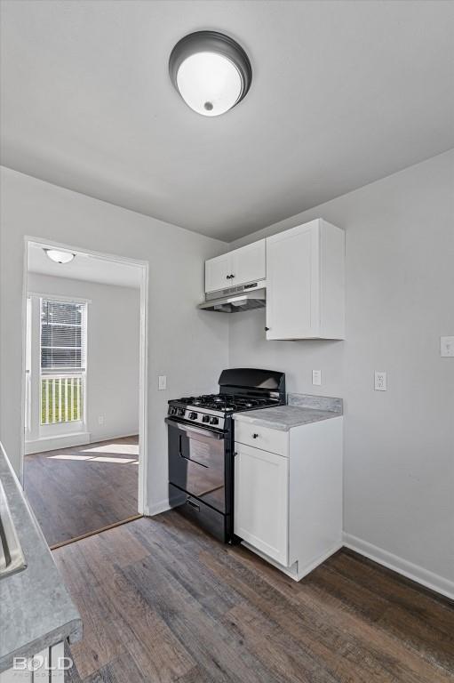 kitchen featuring black gas range oven, under cabinet range hood, white cabinets, and light countertops