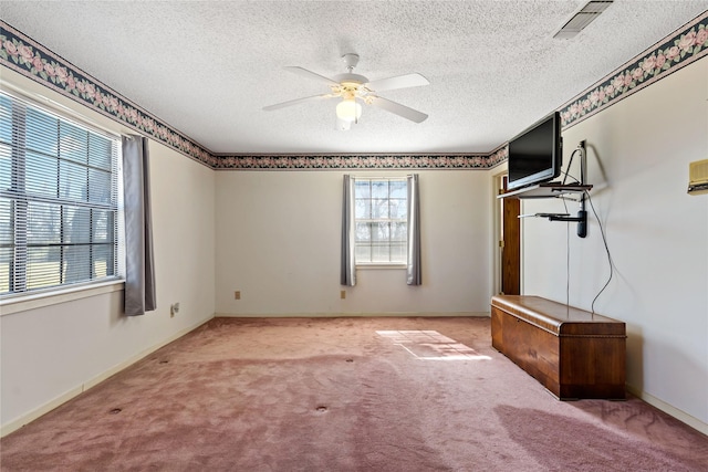 unfurnished bedroom with carpet, visible vents, a ceiling fan, a textured ceiling, and baseboards