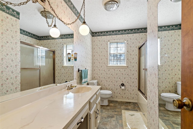 bathroom with toilet and wallpapered walls