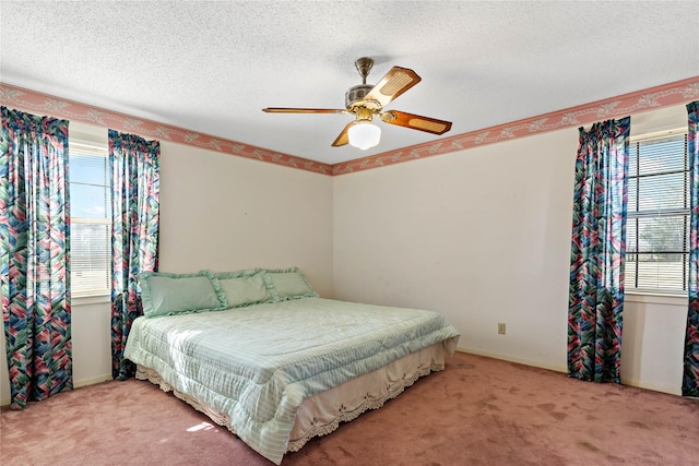 bedroom with carpet, multiple windows, and a textured ceiling