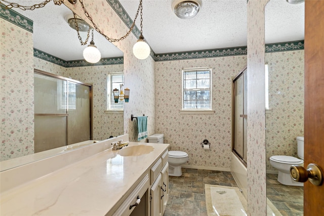 735 State Highway 37 N, Clarksville, TX 75426 - bathroom with a textured ceiling, vanity, and toilet