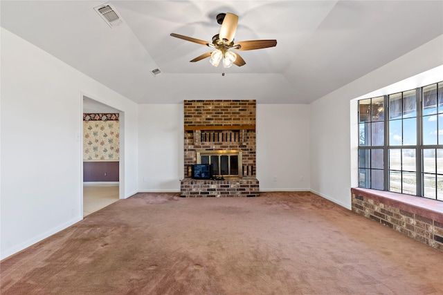 unfurnished living room with visible vents, a ceiling fan, lofted ceiling, carpet, and a fireplace