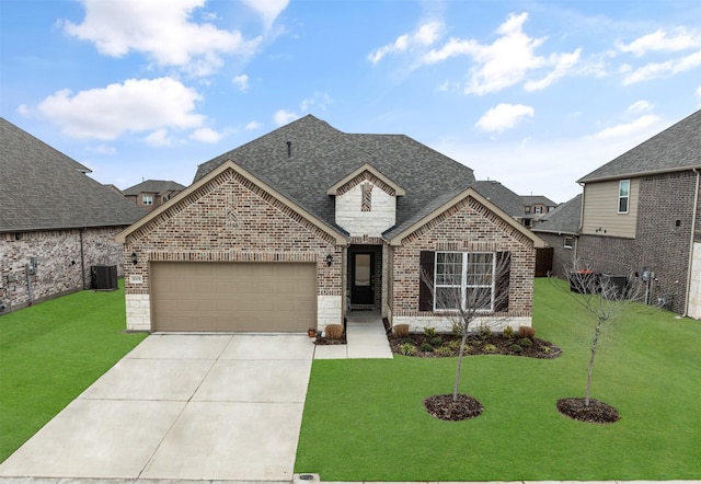 french country inspired facade featuring an attached garage, brick siding, a shingled roof, driveway, and a front yard