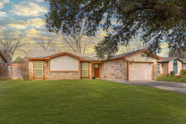 single story home featuring an attached garage, brick siding, fence, concrete driveway, and a front lawn