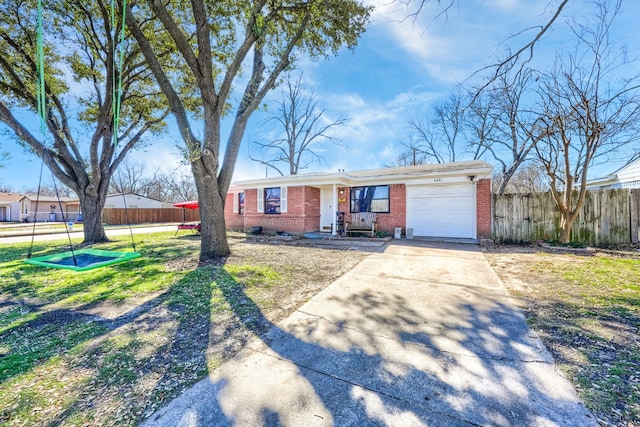 ranch-style house featuring a garage, fence, concrete driveway, and brick siding