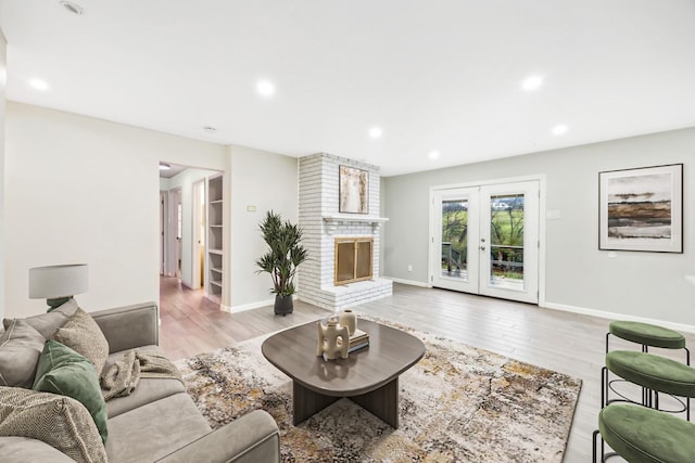 7743 Claremont Dr, Dallas, TX 75228 - living room featuring wood finished floors, baseboards, a brick fireplace, recessed lighting, and french doors