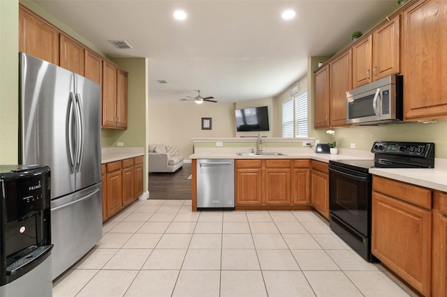 kitchen featuring light tile patterned floors, a sink, visible vents, light countertops, and appliances with stainless steel finishes