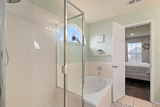 ensuite bathroom with visible vents, a shower stall, a bath, tile patterned floors, and ensuite bath